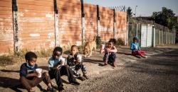 Children in South Africa eat porridge distributed by the non profit organisation and charity group -Hunger has no Religion CREDIT: MARCO LONGARI/AFP